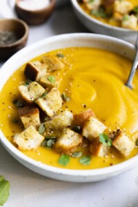 Bowl of healthy butternut squash soup cooked in a slow cooker.