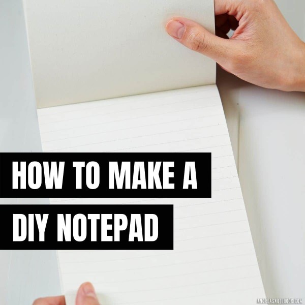 text: how to make a diy notepad - image: white table, lined notepad open on top with two hands holding notepad open. Notepad binding is at top of the notepad.