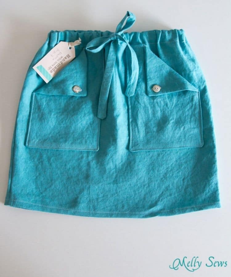 teal linen skirt with drawstring waist on white background