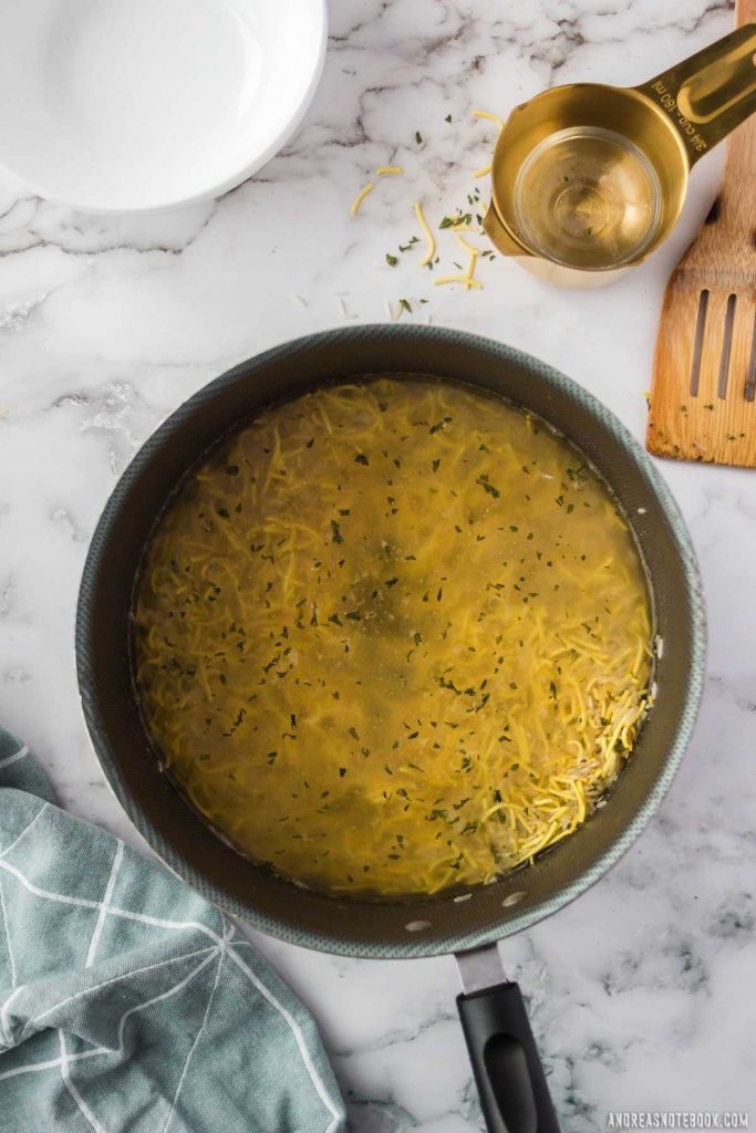 chicken or vegetable broth added to saucepan with rice, pasta and spices.