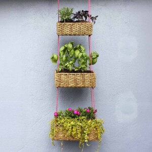 3 tiered hanging baskets with rectangular baskets and pink string.