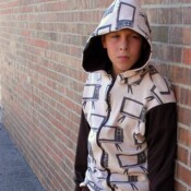 Boy wearing homemade zip up hoodie with hood up.