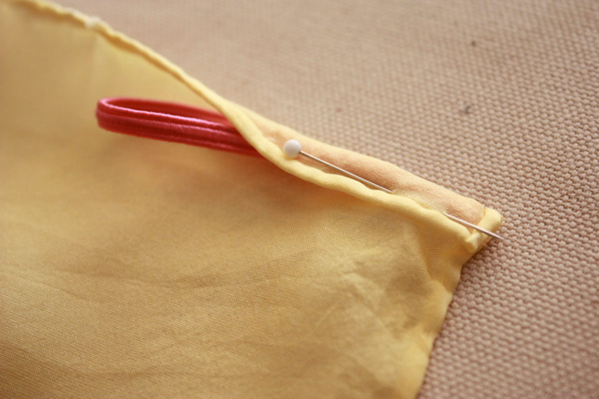 Elastic loops for wrists attached to end of wings.