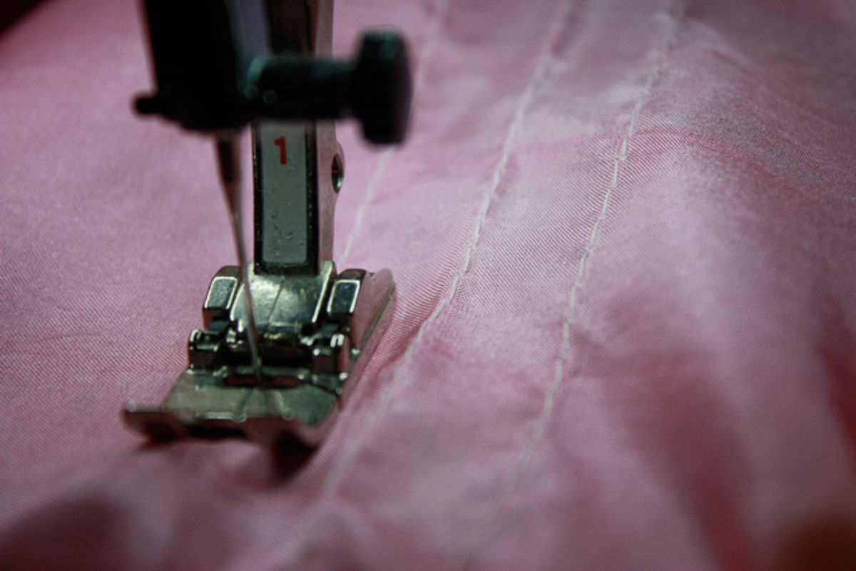 Lines sewn on pink fabric.