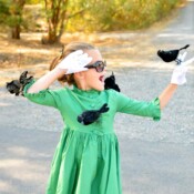 Young girl wearing a DIY Melanie Daniels The Birds costume with fake birds on her.