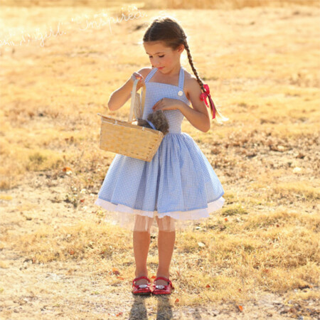 Girl in DIY Dorothy Wizard of Oz dress holding a basket.