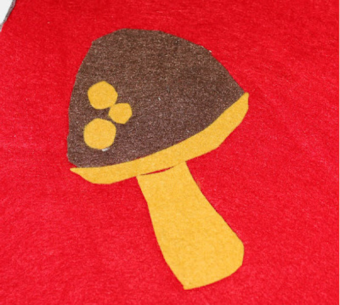 Close up of the yellow and brown mushroom applique on the felt gnome hat.