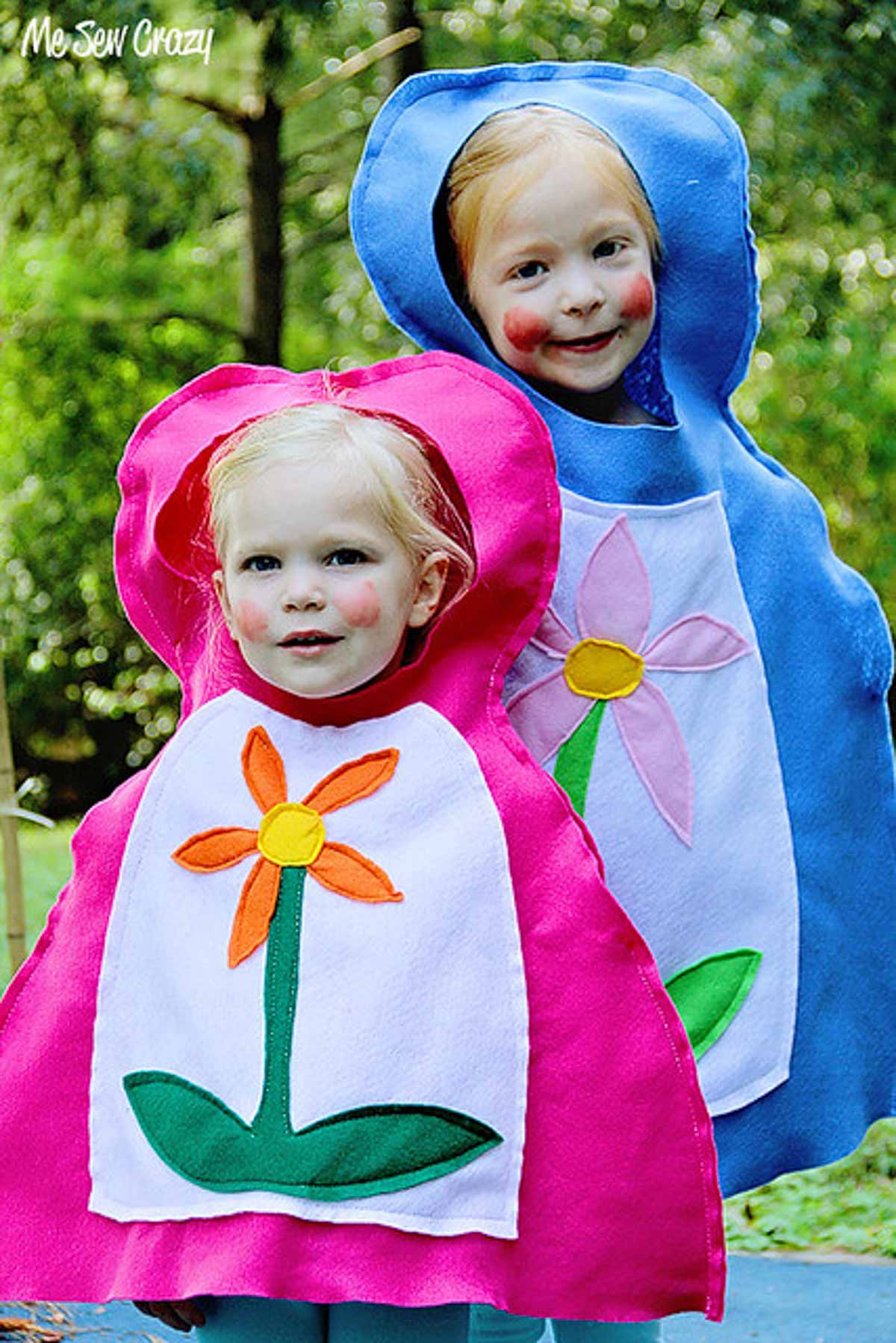 Two children wearing DIY Russian nesting doll costumes (Matryoshka) in pink and blue.