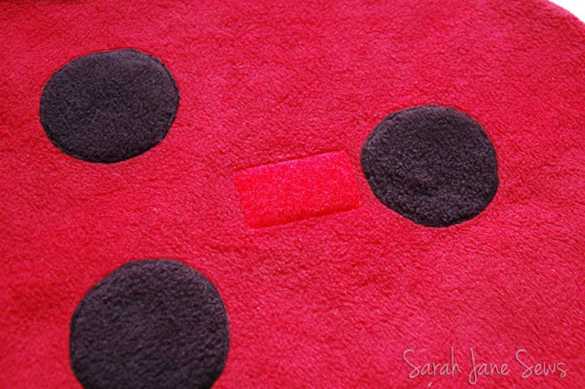 Velcro sewn onto ladybug fabric.