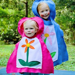 Two children wearing DIY Russian nesting doll costumes (Matryoshka) in pink and blue.