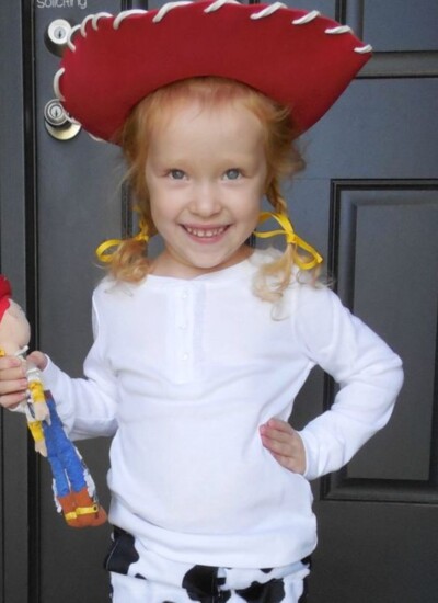 DIY Jessie costume from toy story: Little girl wearing costume holding Jessie doll.