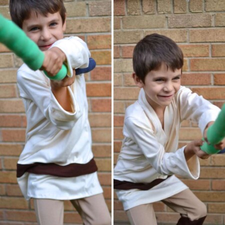 Boy wearing homemade luke skywalker costume and homemade lightsaber.