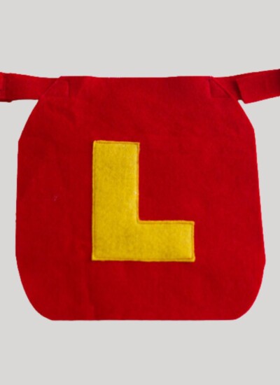 Red dog cape with buckle collar and big yellow "L" on it.