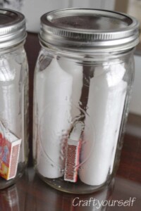 Candles and matches in a mason jar.