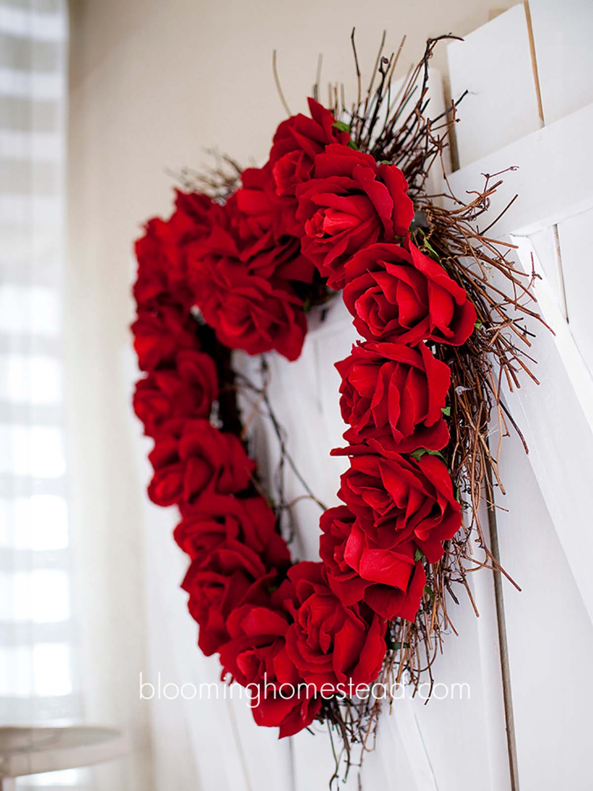 valentine's day wreath ideas: DIY red faux rose wreath on twig heart wreath background.