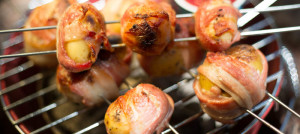 Bacon wrapped potato skewers roasted over a campfire. Yum!