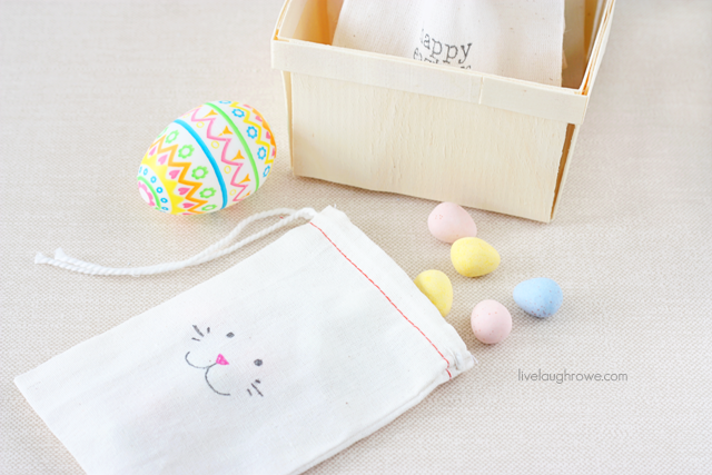 Draw a bunny face on a muslin bag with fabric pens