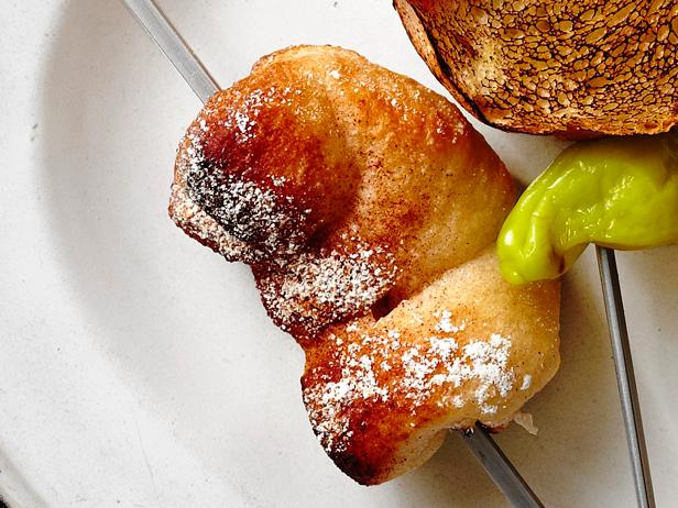 Simple dough cooked on a stick and sprinkled with cinnamon and sugar.