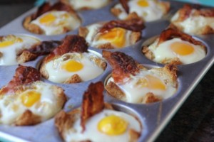 Toast, eggs, and bacon bowls cooked in a muffin tin.