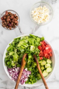 Greek salad ingredients in a bowl, not tossed.