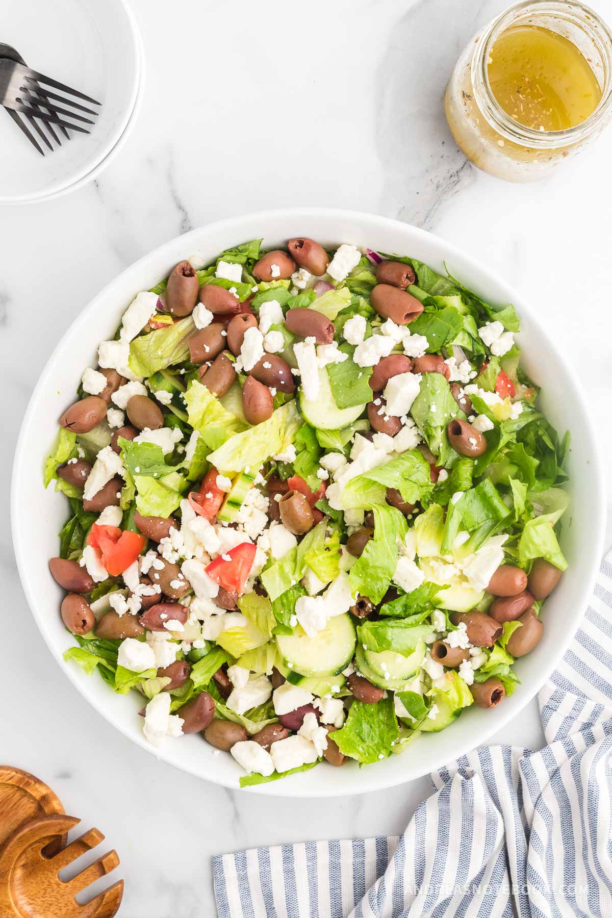 Mixed up greek salad in a bowl.