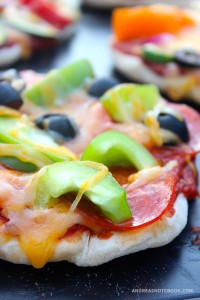 Pizza with green peppers and pepperoni.
