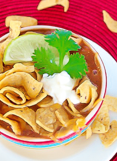taco soup with fritos in a bowl on red placemat