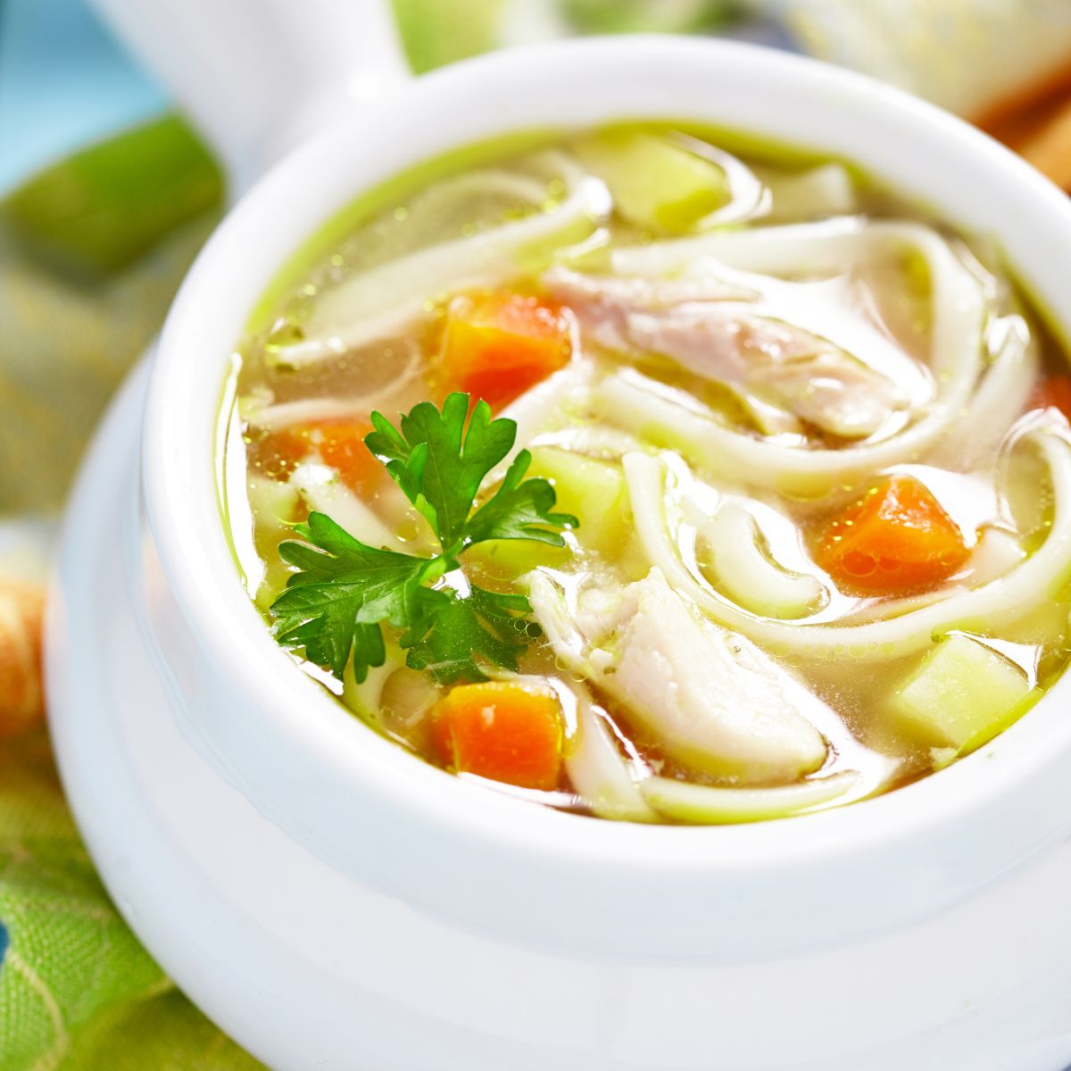 chicken noodle soup in a white bowl.