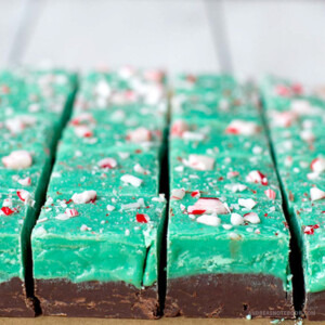 Squares of chocolate and green mint fudge in rows with candy cane sprinkles on top.