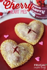 Two heart shaped mini cherry pies on a red plate.