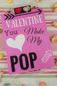 Pink valentine card with a heart that says "valentine you make my pop".