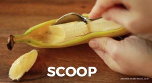 Spoon scooping out banana out of peel.