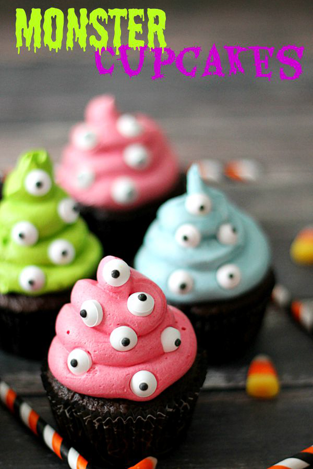 Silly Halloween monster eye cupcakes with colorful frosting and candy eyeballs on top.