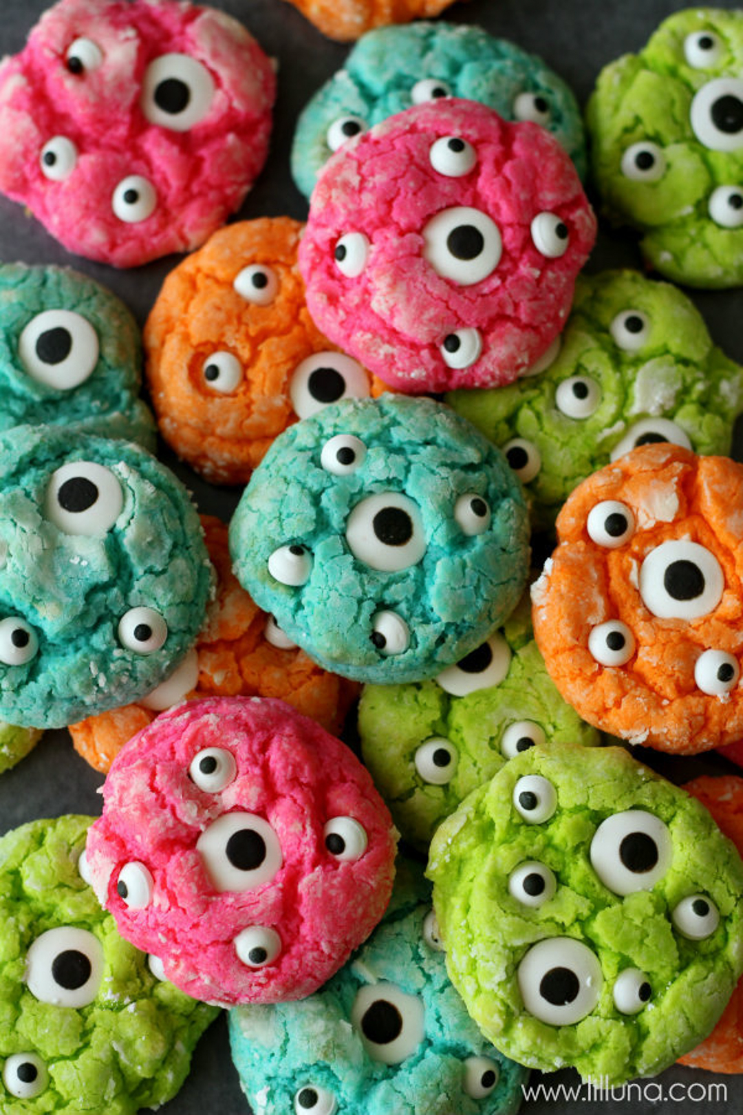 Colorful monster eye cookies in pink, green, orange and aqua.