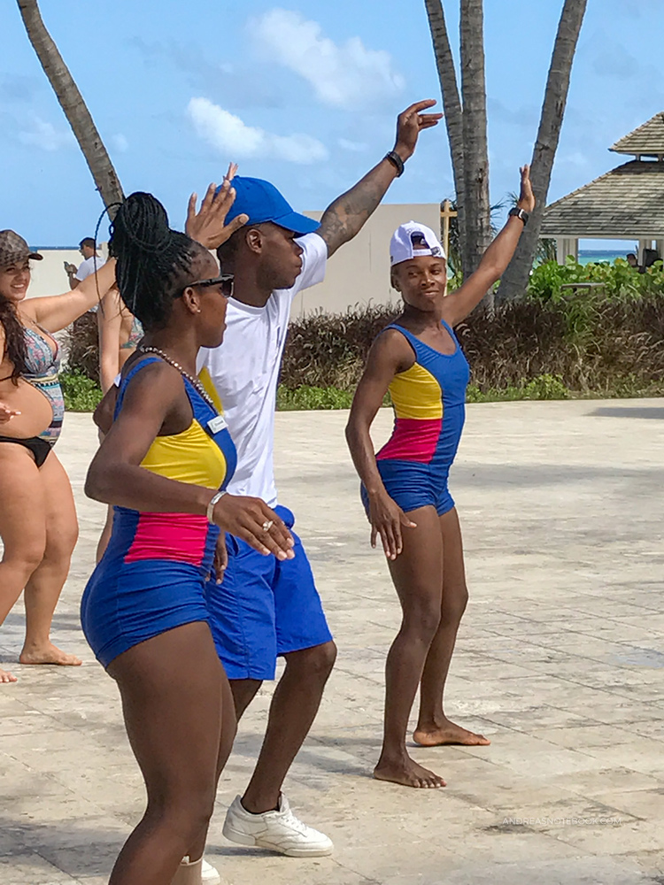 All-inclusive resorts have lots of poolside entertainment and activities. Join in! Here, three dancers are teaching the guests to dance like a local!