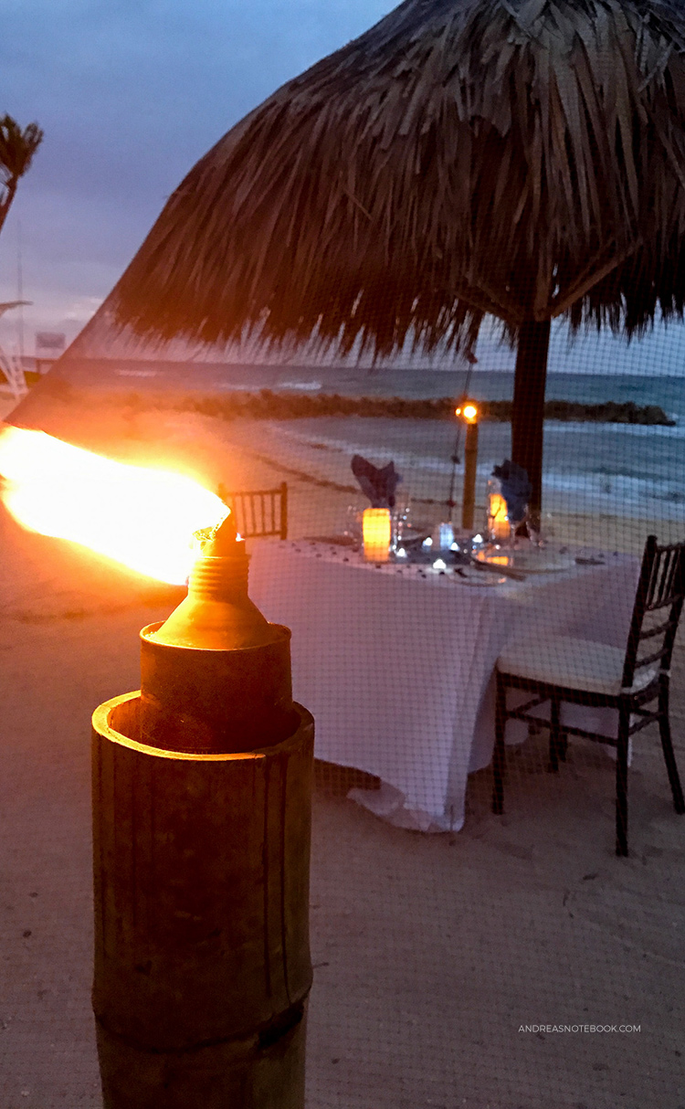 Many all-inclusive resorts have fun activities at night. Take advantage of those! This table was set up under a mosquito net for a private beach dinner.