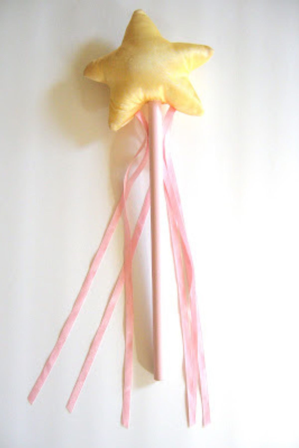 Pink handled DIY fairy wand with yellow star on top.