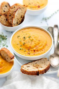 instant pot curried butternut squash soup white bowl crusty bread