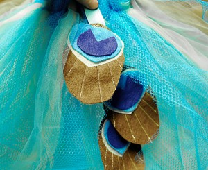 Ribbon with DIY peacock feathers sewn to tutu.