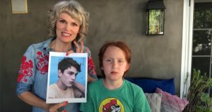 blonde woman holds photo of man with nice brown hair next to red headed son