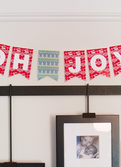 "oh joy" christmas bunting on wall above photo frames