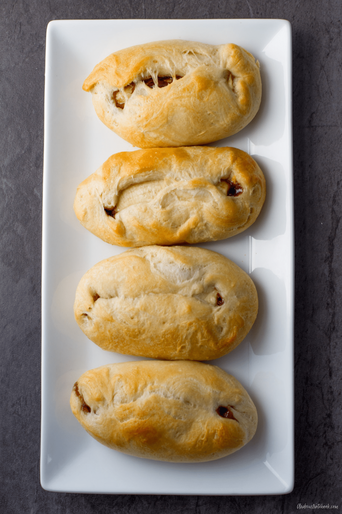 4 banana nutella filled biscuits on a rectangular white plate