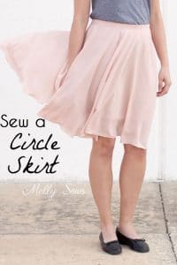 lower half of woman wearing thin beautiful light pink circle skirt blowing in the wind