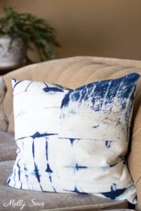 blue and white shibori dyed pillow on beige couch with invisible zipper sewn with an invisible zipper foot.