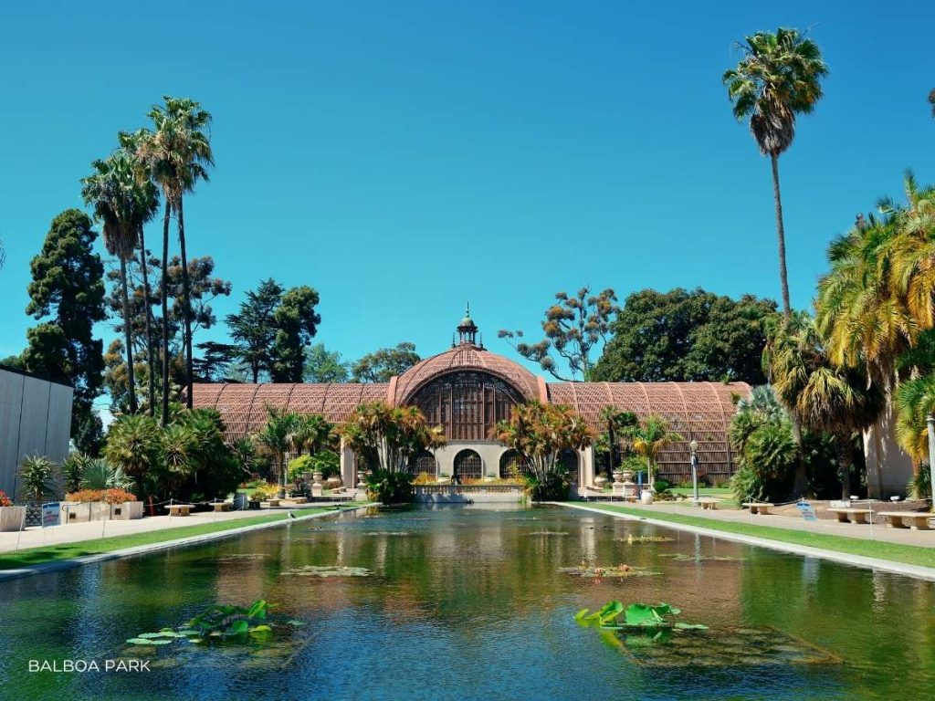 building at balboa park with square water pond in front