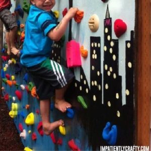 close up view of kid climbing colorful climbing wall