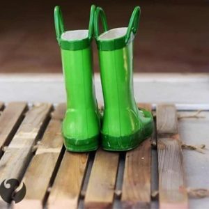 wood plant shoe mat with green small rubber boots