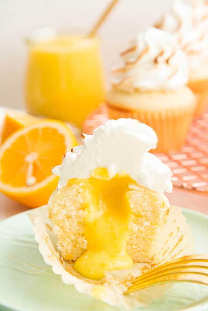 lemon meringue cupcakes with bite out.