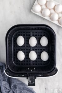 Eggs in an air fryer basket.