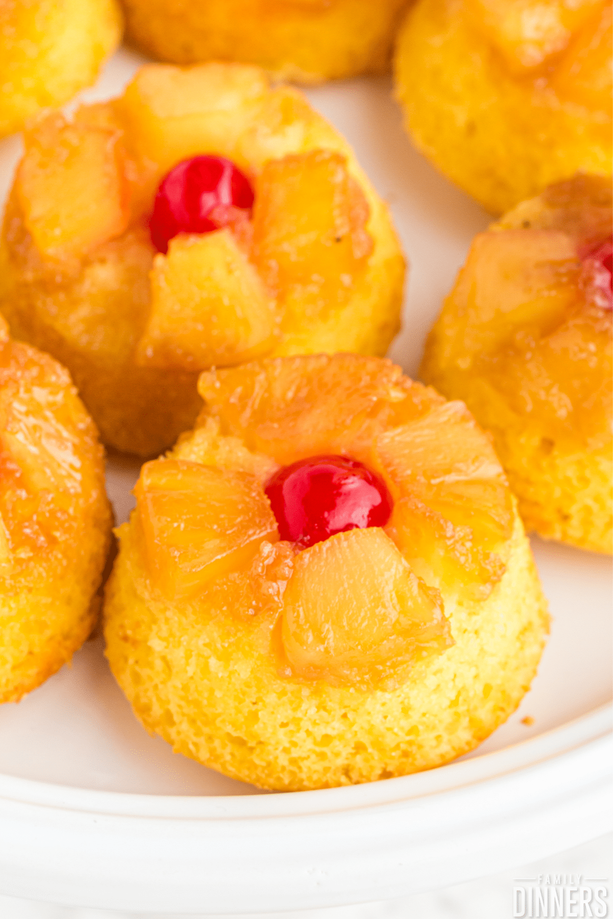 Pineapple upside down cakes on a plate.
